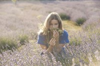 Woman in Field smelling flowers