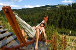 Sleep. A man sleeping in a hammock in the mountains.