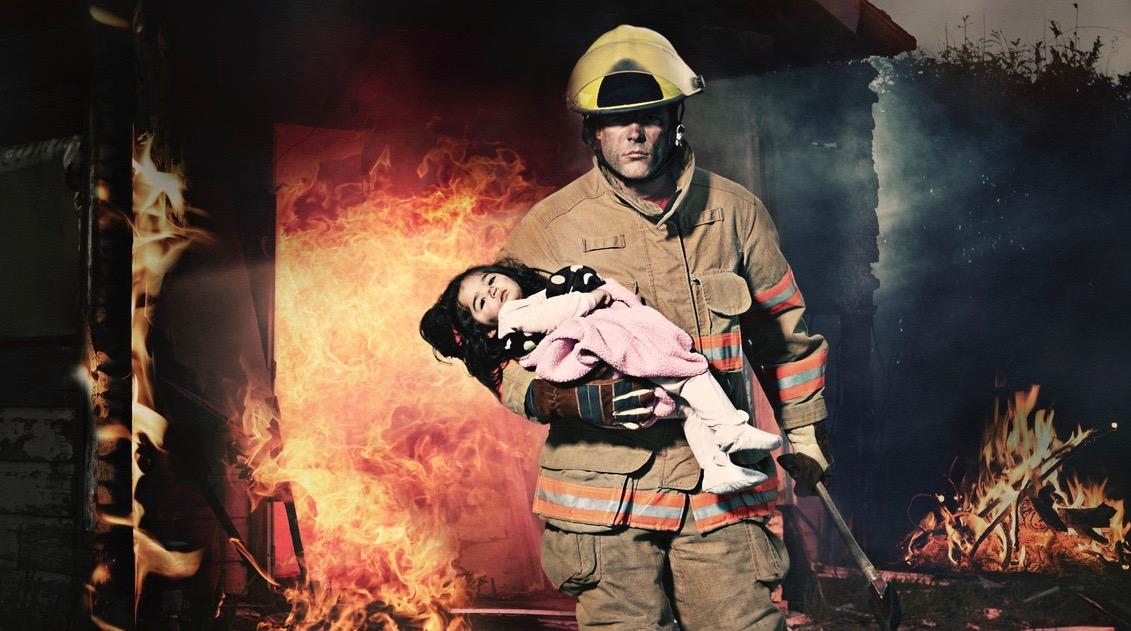 Hero. Fireman Rescuing a Baby From Burning House