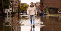 Crisis. Man walking on the flooded street after Hurricane Sandy landfall